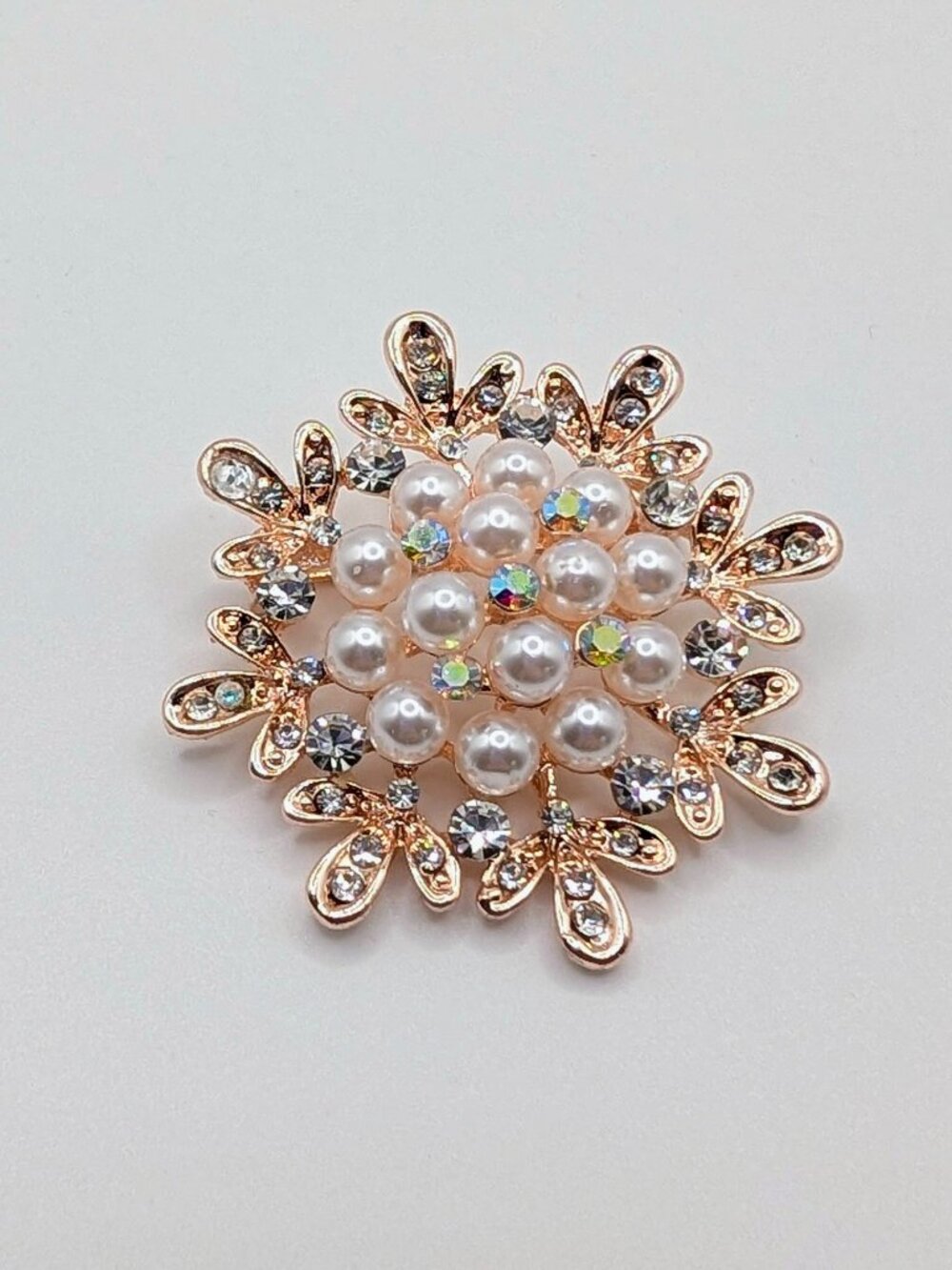 A Rose Gold -Tone Brooch in a Snowflake Design